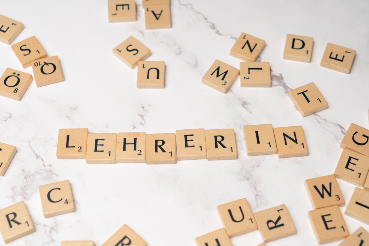 Scrabble tiles spelling 'Lehrerin', symbolizing education and language on a marble background.